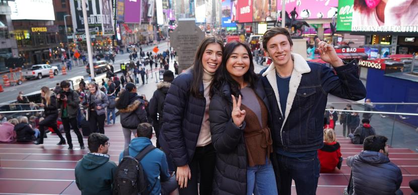 students on times square doing a picture