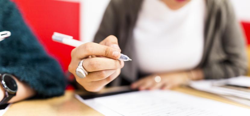 student writing on paper