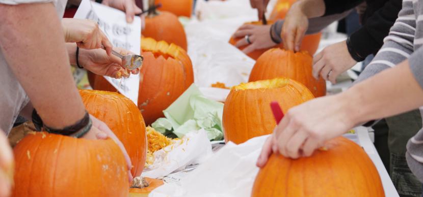 students carving pumpkin