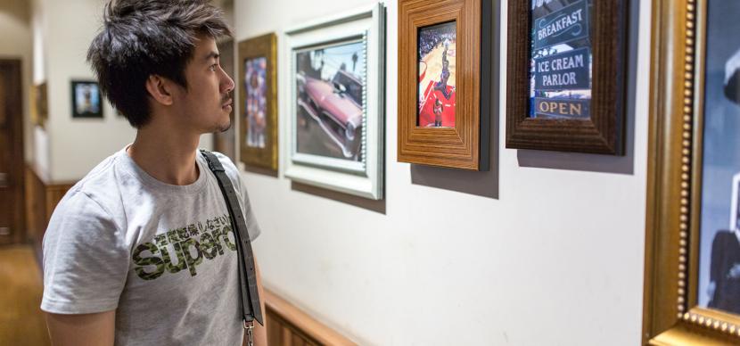 student looking at art in a museum