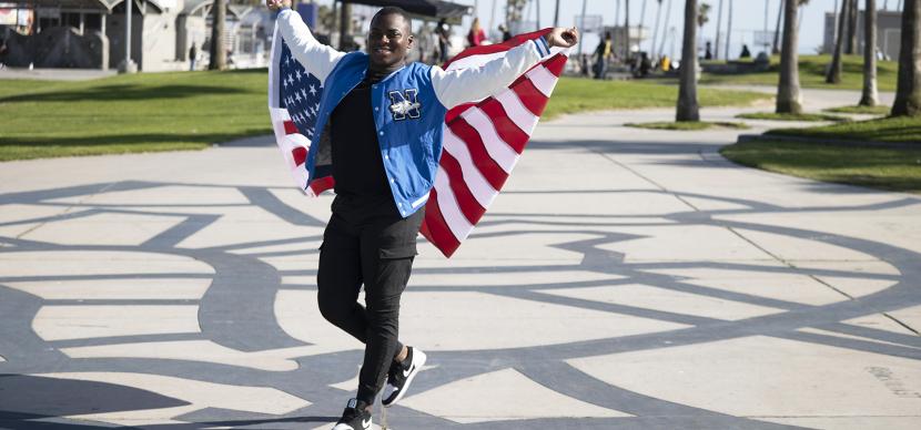 student holding an american flag