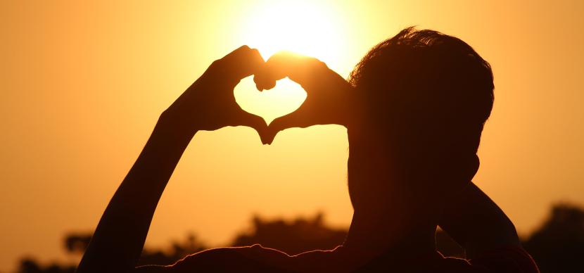 person doing a heart with his hands