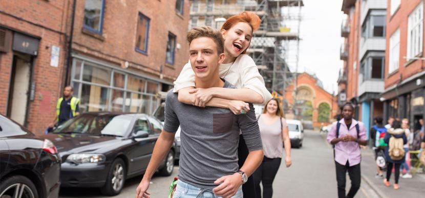 two students having fun in the street