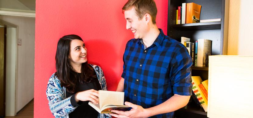 students looking at a book together