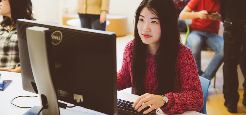 student in front of a computer