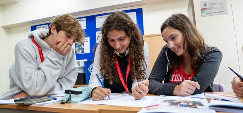 3 students studying in a classroom