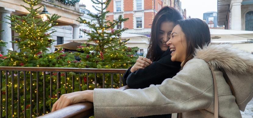 two students laughing inside covent garden market