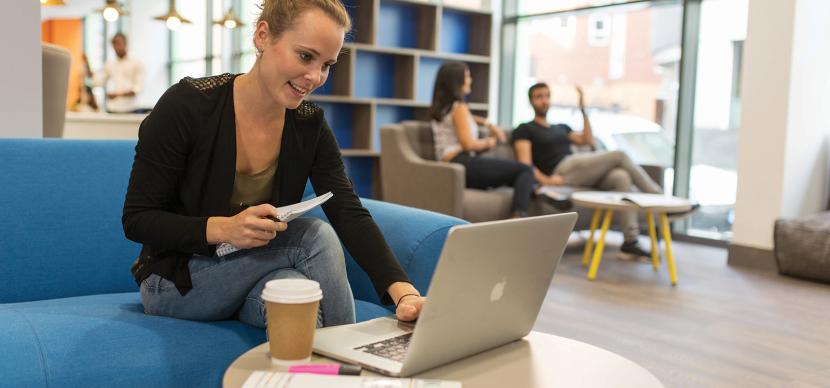 student smiling while working