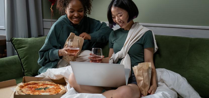 girls watching a movie together on a laptop