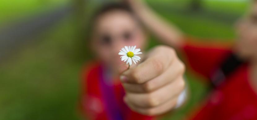 student holding a flower