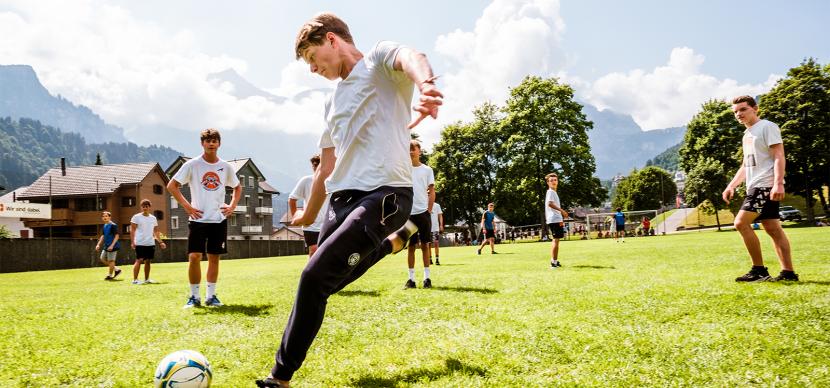 student playing football outside