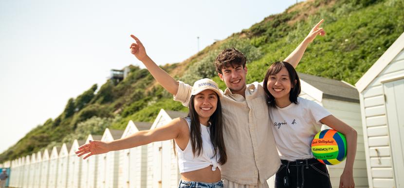 3 students on a beach in bournemouth