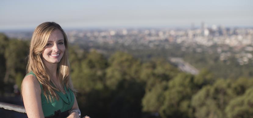 student in front of brisbane