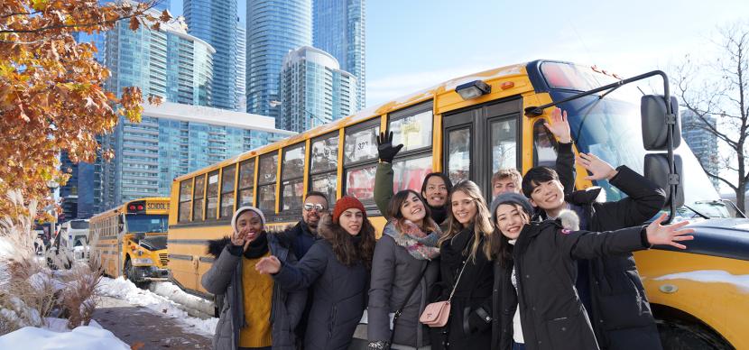 students in front of an american bus