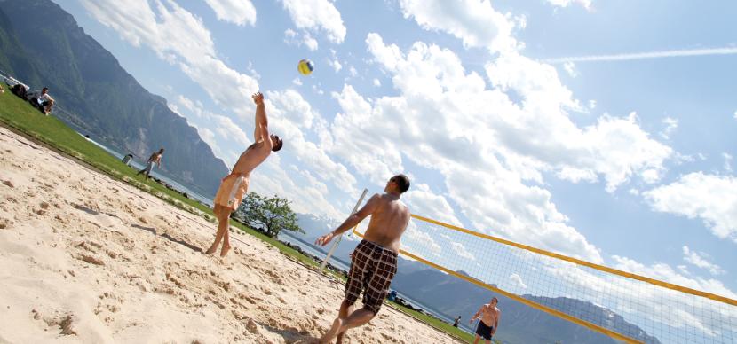 students playing volleyball on the beach