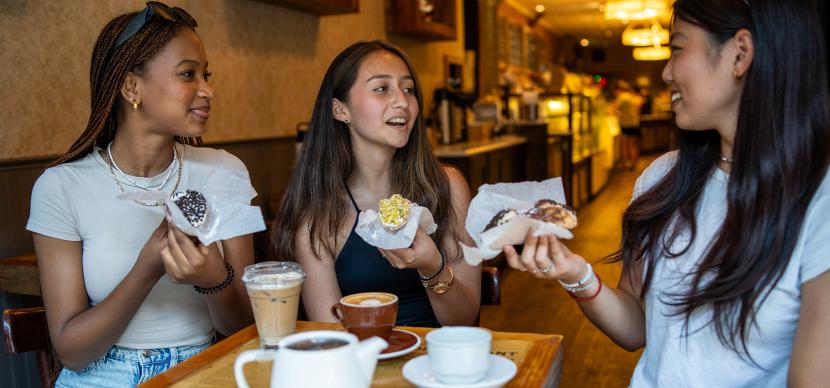 students eating cake in a coffee shop