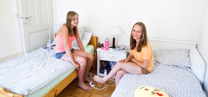 two students sitting on their beds