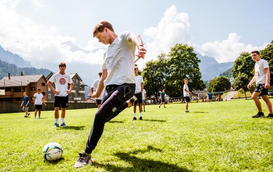 student playing football outside