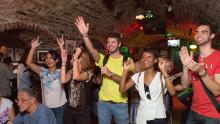 people cheering in a bar