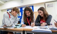 3 students studying in a classroom