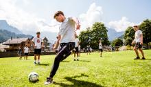 student playing football outside