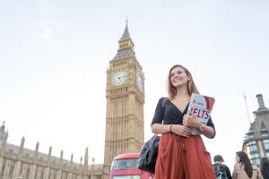 Girl with a brochure in front of Big Ben