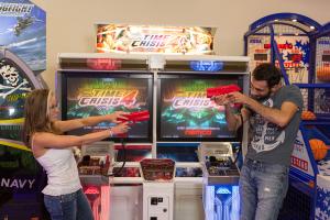 two students playing in a video game center