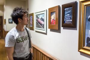 student looking at art in a museum