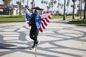 student holding an american flag