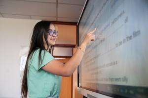 student touching a screen