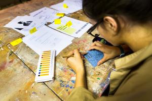 Student doing art on a table