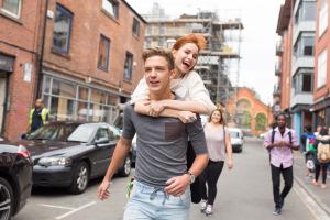 two students having fun in the street