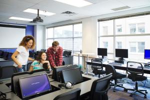 students looking at a screen in a classroom