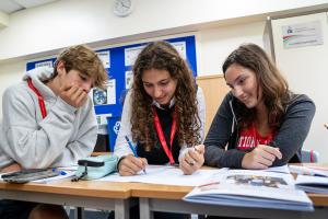 3 students studying in a classroom