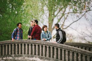 students talking together on a bridge