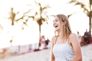 girl laughing on the beach