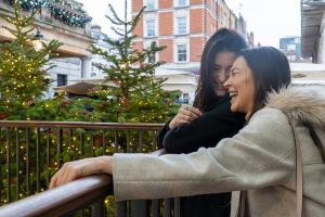 two students laughing inside covent garden market