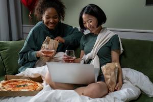 girls watching a movie together on a laptop