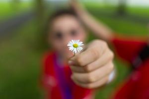 student holding a flower