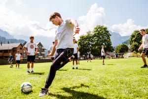 student playing football outside