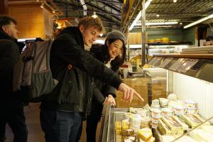 students looking at food in a market