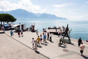 people walking near Geneva Lake in Montreux