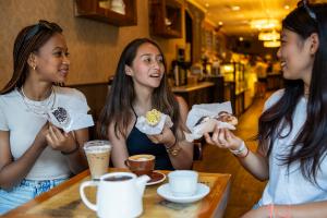 students eating cake in a coffee shop