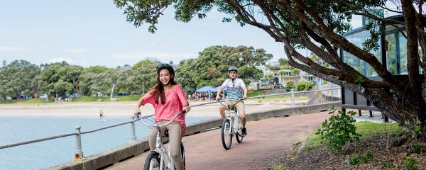 students biking near the sea