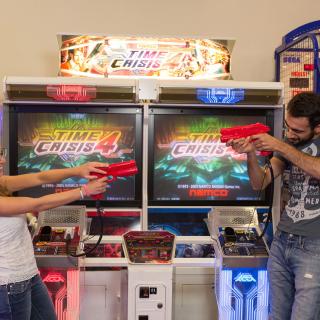 two students playing in a video game center
