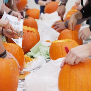 students carving pumpkin