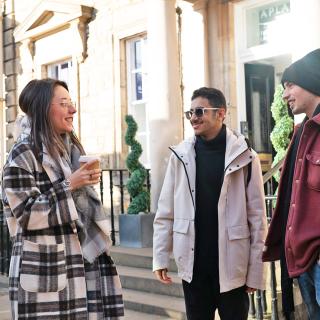 3 students talking together in the street