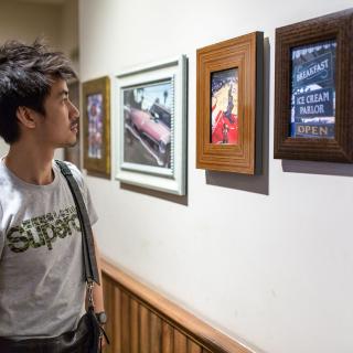 student looking at art in a museum