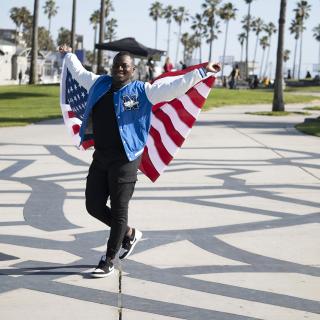 student holding an american flag