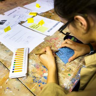 Student doing art on a table